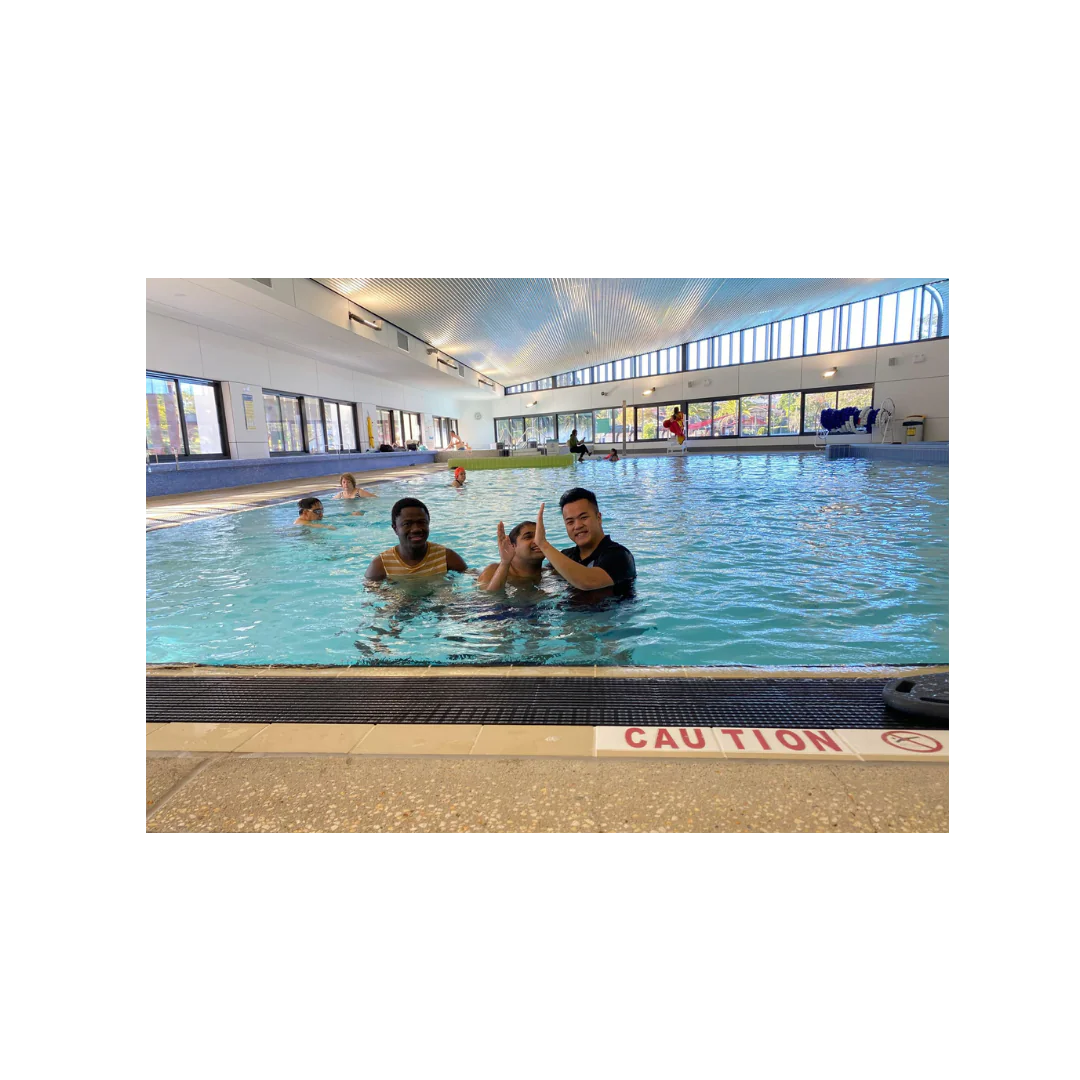 Group hydrotherapy session with multiple clients receiving guided aquatic physiotherapy