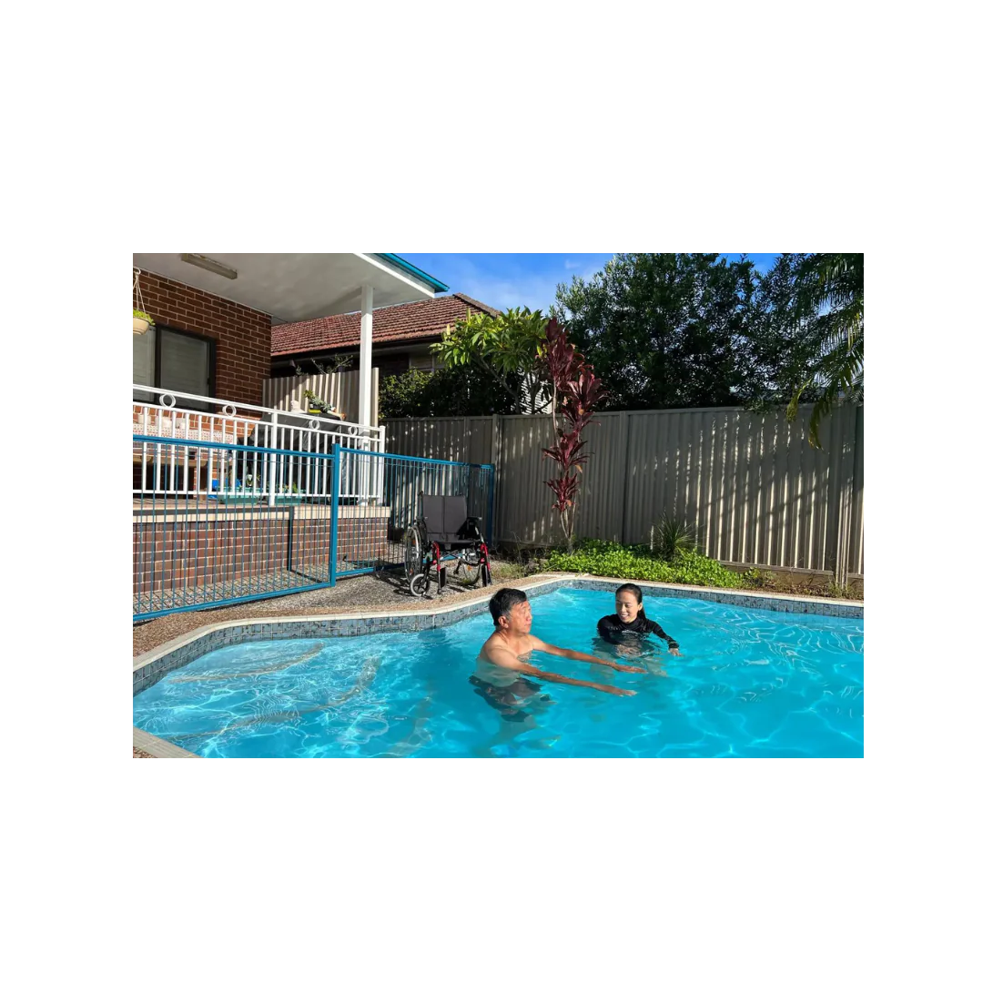 Outdoor hydrotherapy session with physiotherapist assisting client in water-based rehab exercises