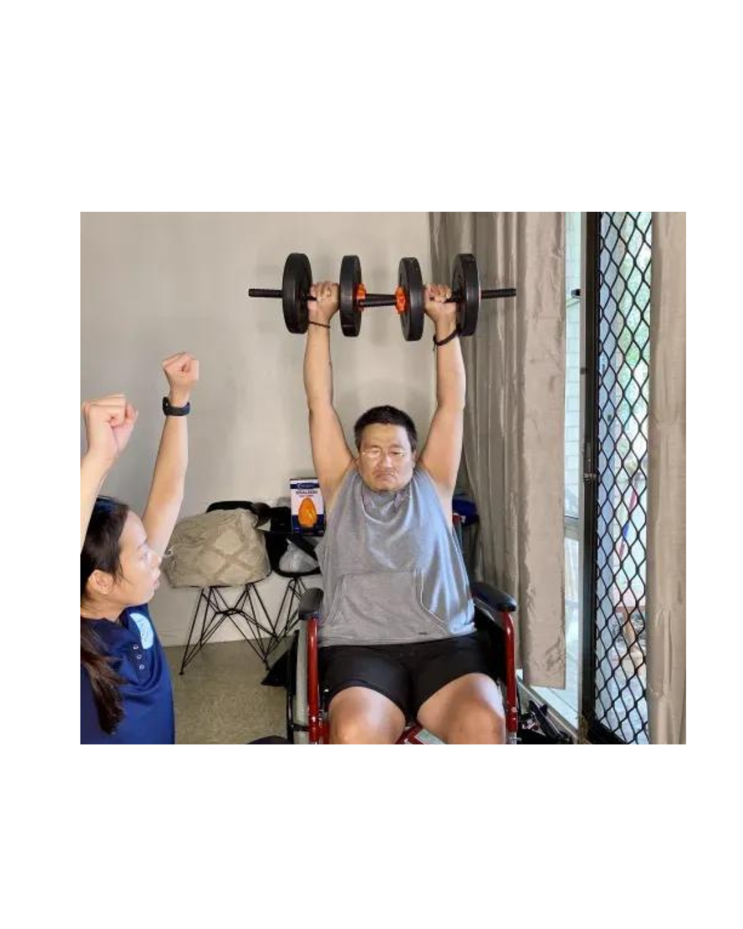 Client performing shoulder strength exercises with physiotherapist supervision during home rehab session