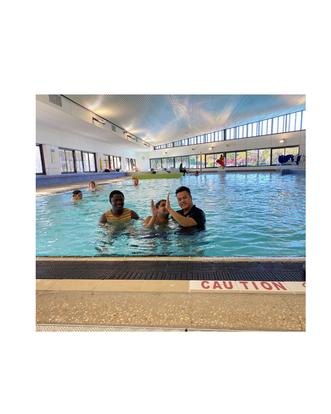 Group hydrotherapy session with clients supported by physiotherapist in indoor rehabilitation pool