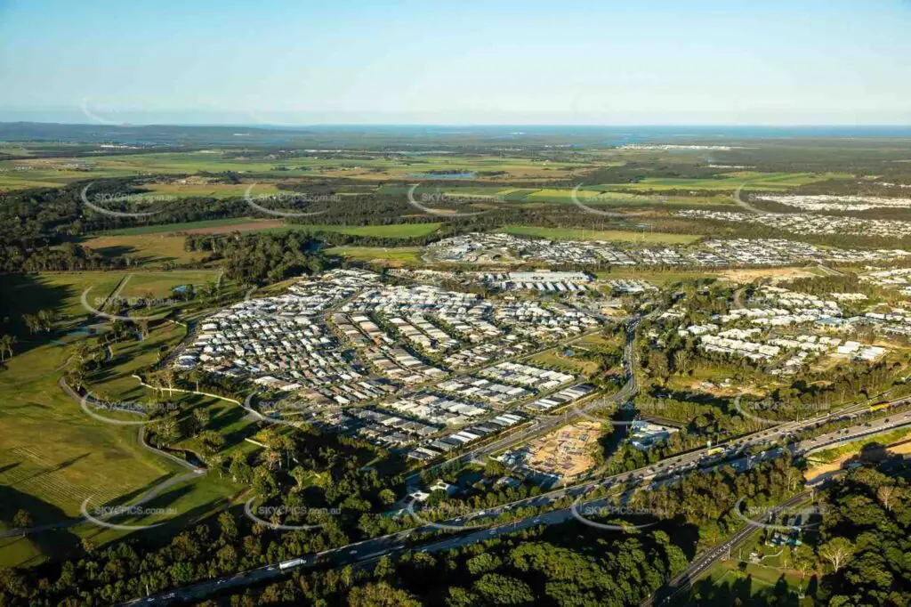 Aerial view of suburban Pimpama, Queensland, showing residential neighbourhoods and open green spaces—ideal for delivering mobile physiotherapy services in-home or in local parks and community areas.