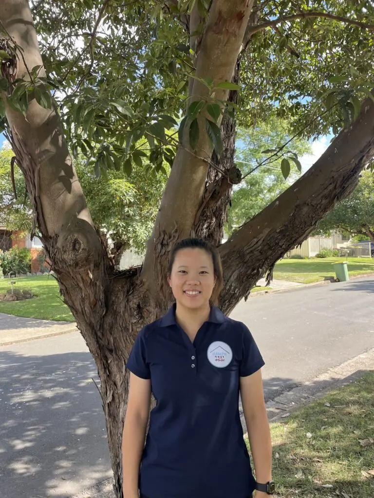 A mobile physiotherapist standing behind a tree ready to give mobile physiotherapy!