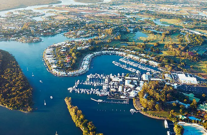 Aerial view of marina-lined Hope Island in North Gold Coast—serviced by mobile physiotherapists delivering in-home NDIS, aged care, and rehab support across northern suburbs.