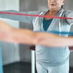 Elderly woman doing guided physiotherapy exercises
